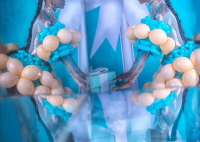 A breathtaking fine art and high-fashion portrait by Victoria Machin Photography, featuring a model in balloon couture, body paint, and avant-garde styling. The mirror illusion effect and Tiffany blue-inspired backdrop add a surreal, editorial touch to this award-winning fine art composition.