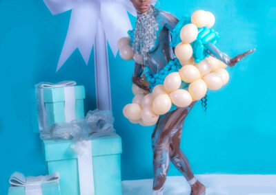 A breathtaking fine art and high-fashion portrait by Victoria Machin Photography, featuring a model in balloon couture, body paint, and avant-garde styling. The mirror illusion effect and Tiffany blue-inspired backdrop add a surreal, editorial touch to this award-winning fine art composition.