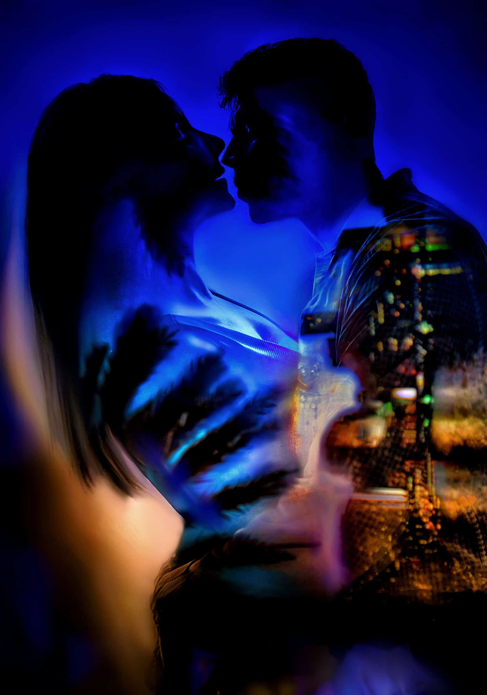 Fine-art double exposure of a couple about to kiss, Miami city lights glowing through them