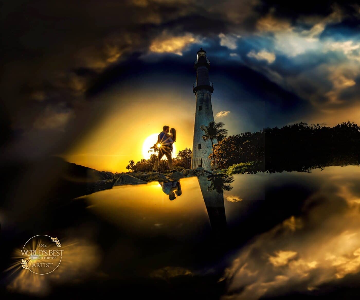 Couple silhouetted against the setting sun beside a lighthouse, reflected in still water