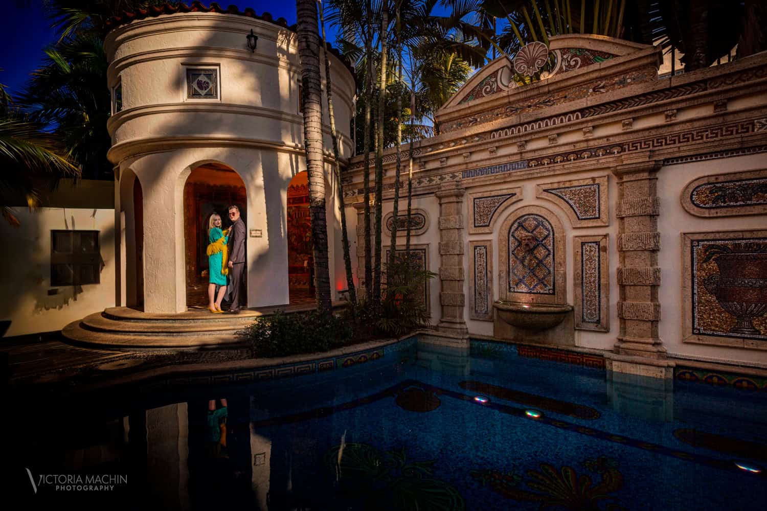 Couple in the arched doorway beside the mosaic pool at Villa Casa Casuarina (Versace Mansion), Miami Beach