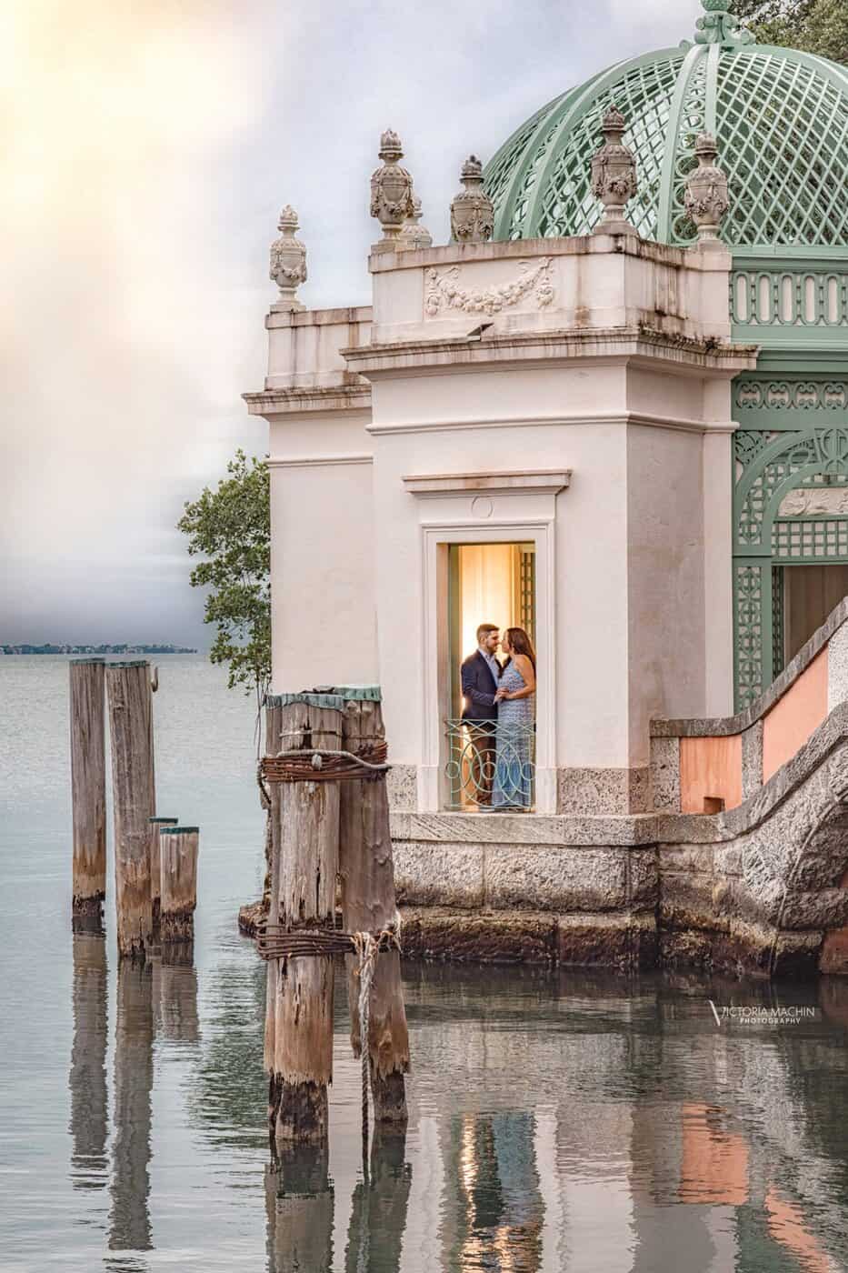Couple embracing inside the waterfront tea house at Vizcaya Museum and Gardens