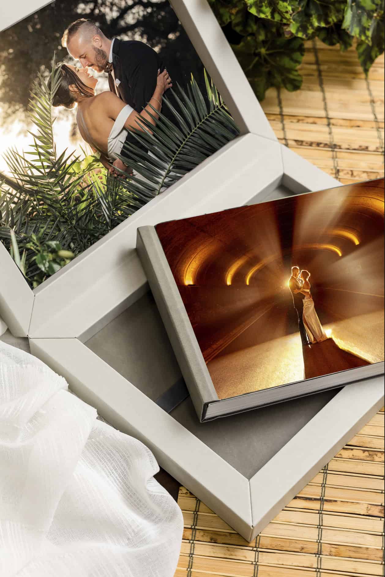 Two heirloom wedding albums with photo covers in linen presentation boxes